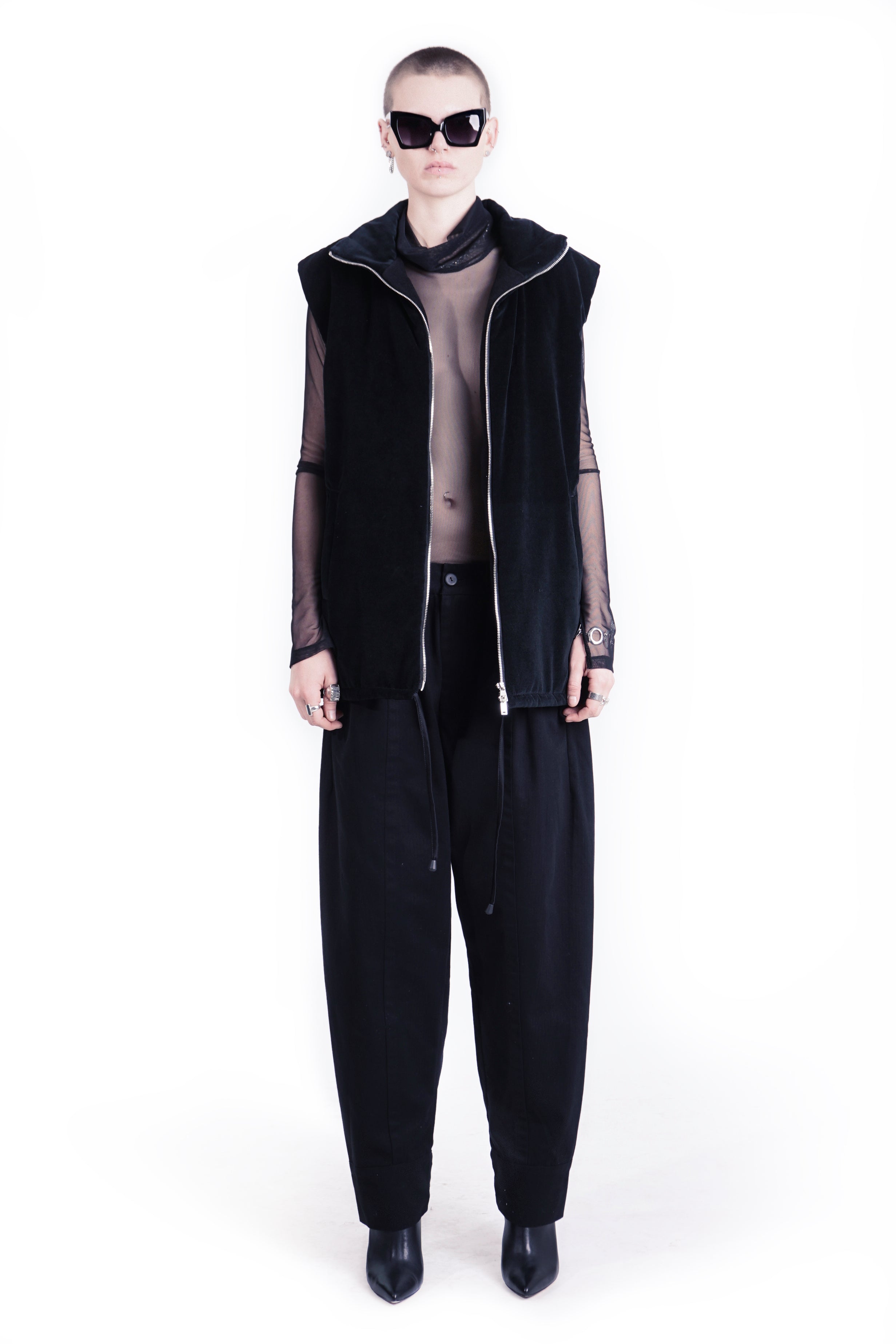 Front view of oversized black hooded vest with zip closure