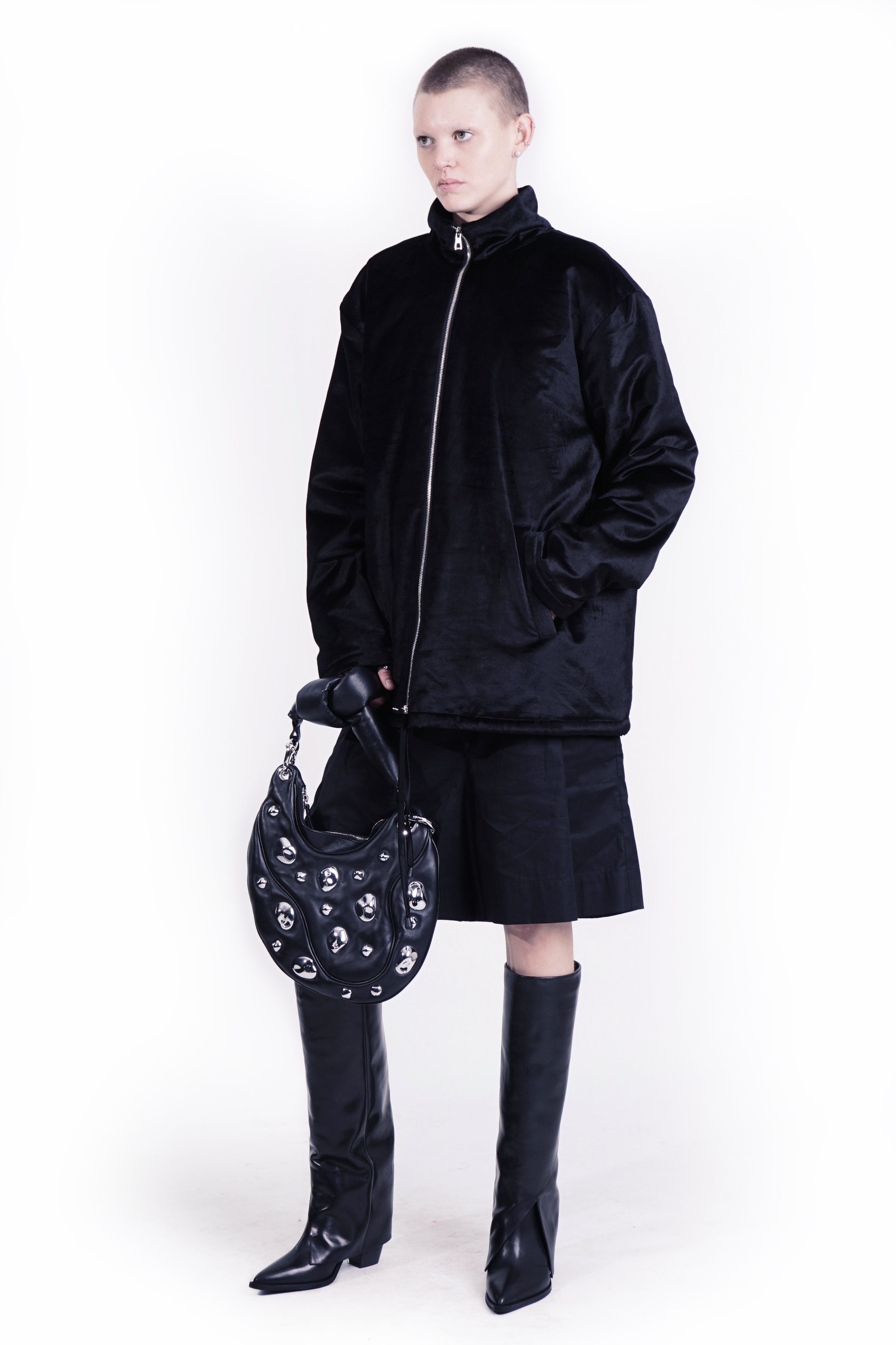 Side view of relaxed velvet jacket jacket styled with wide-leg trousers