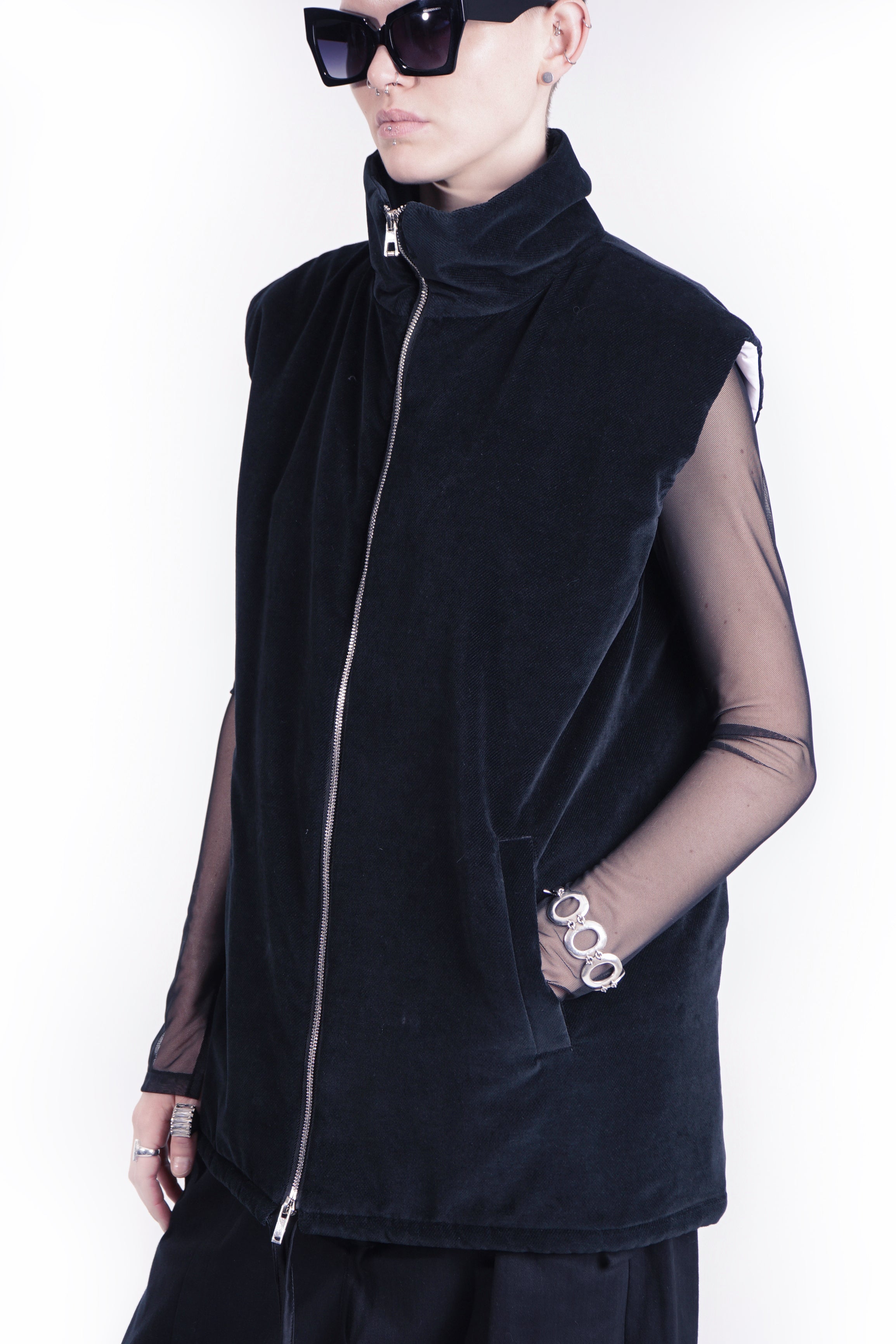 side view of oversized black outerwear vest woth stand collar 