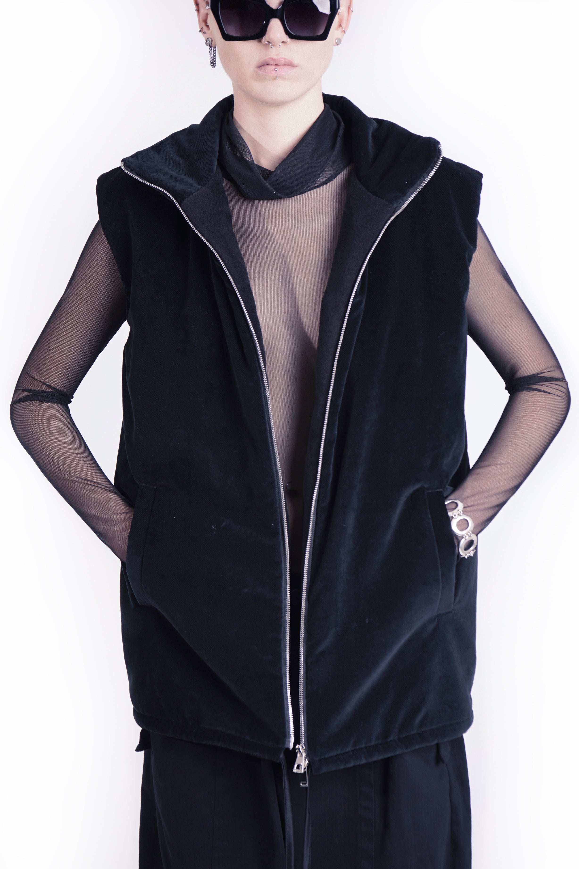 Front view of oversized black outerwear vest woth stand collar  and zip closure