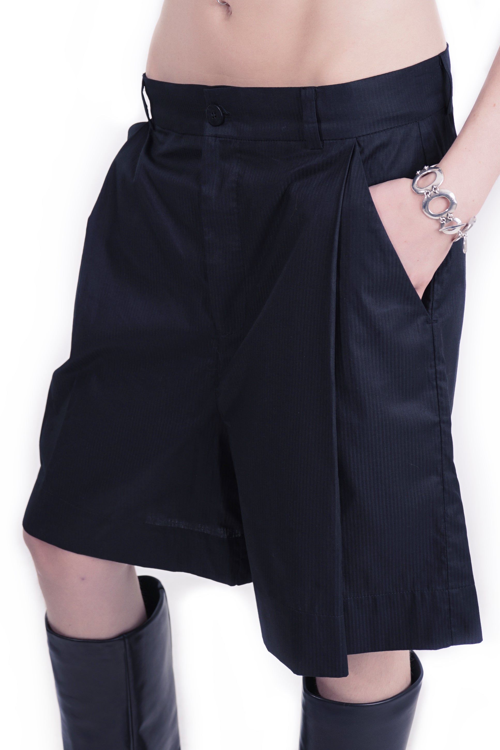 Waistband detail with concealed closure and pleated front