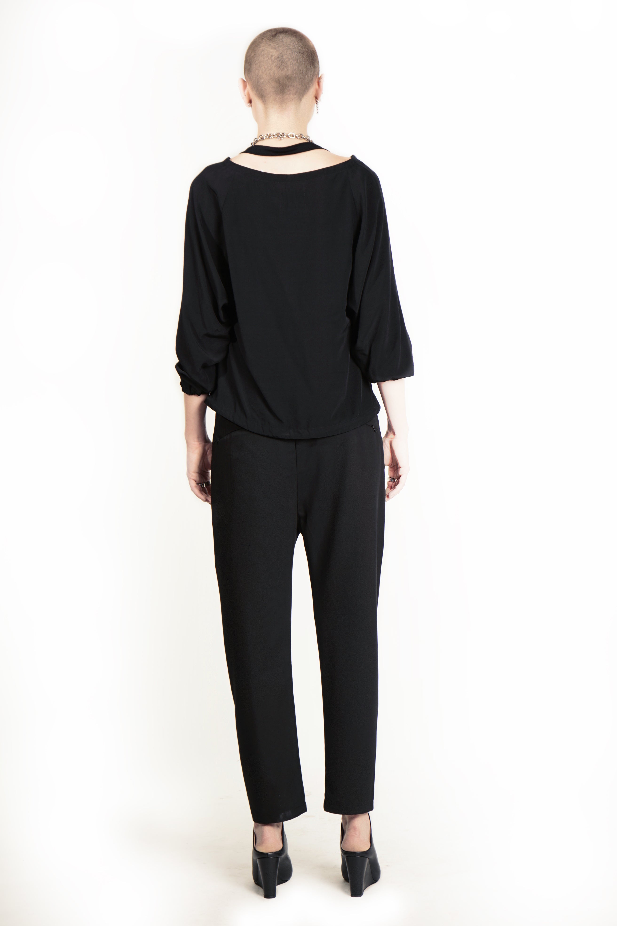 Back view of tapered trousers with zip pockets
