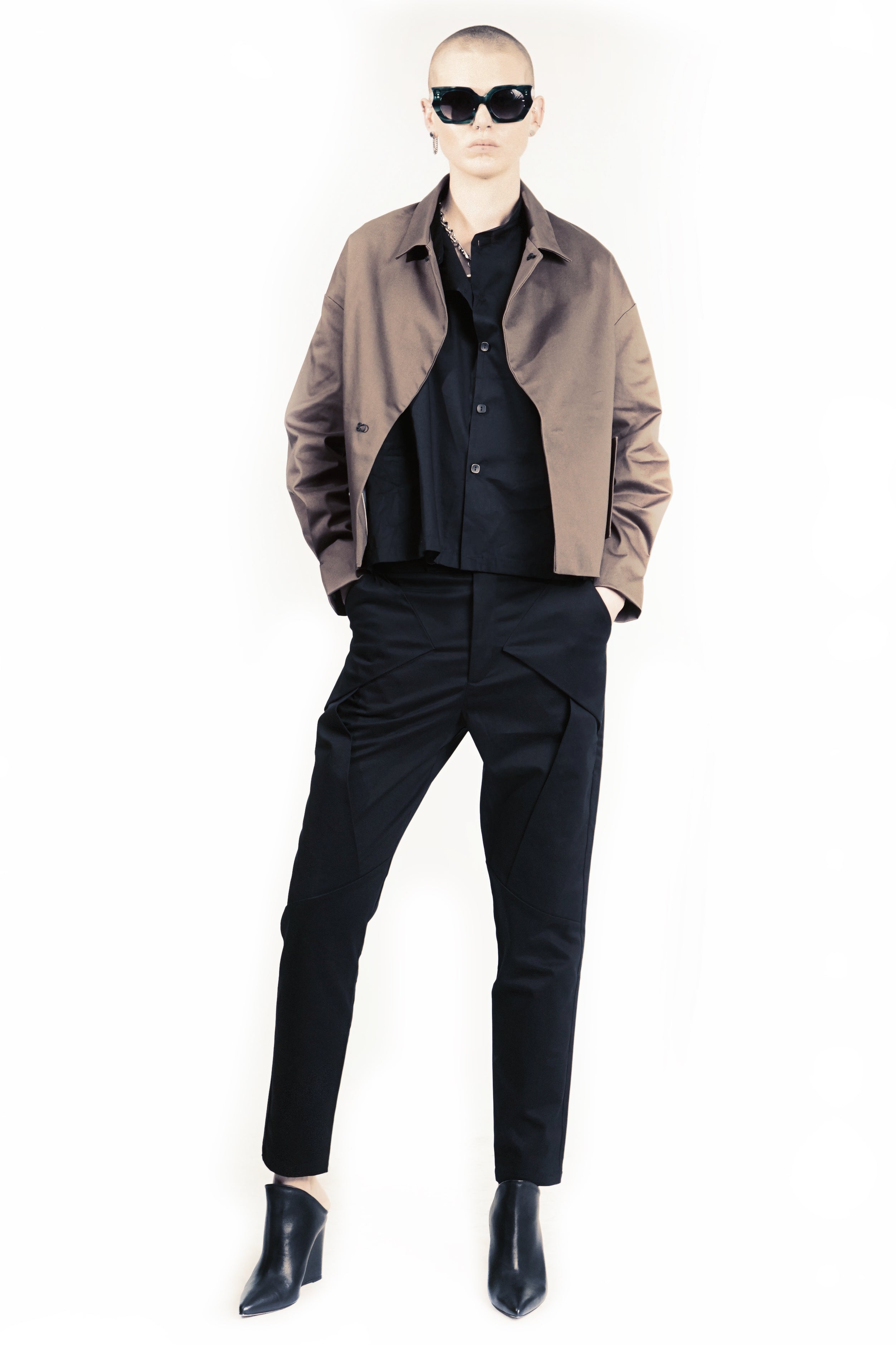 Front view of slim black trousers with layered geometric panels