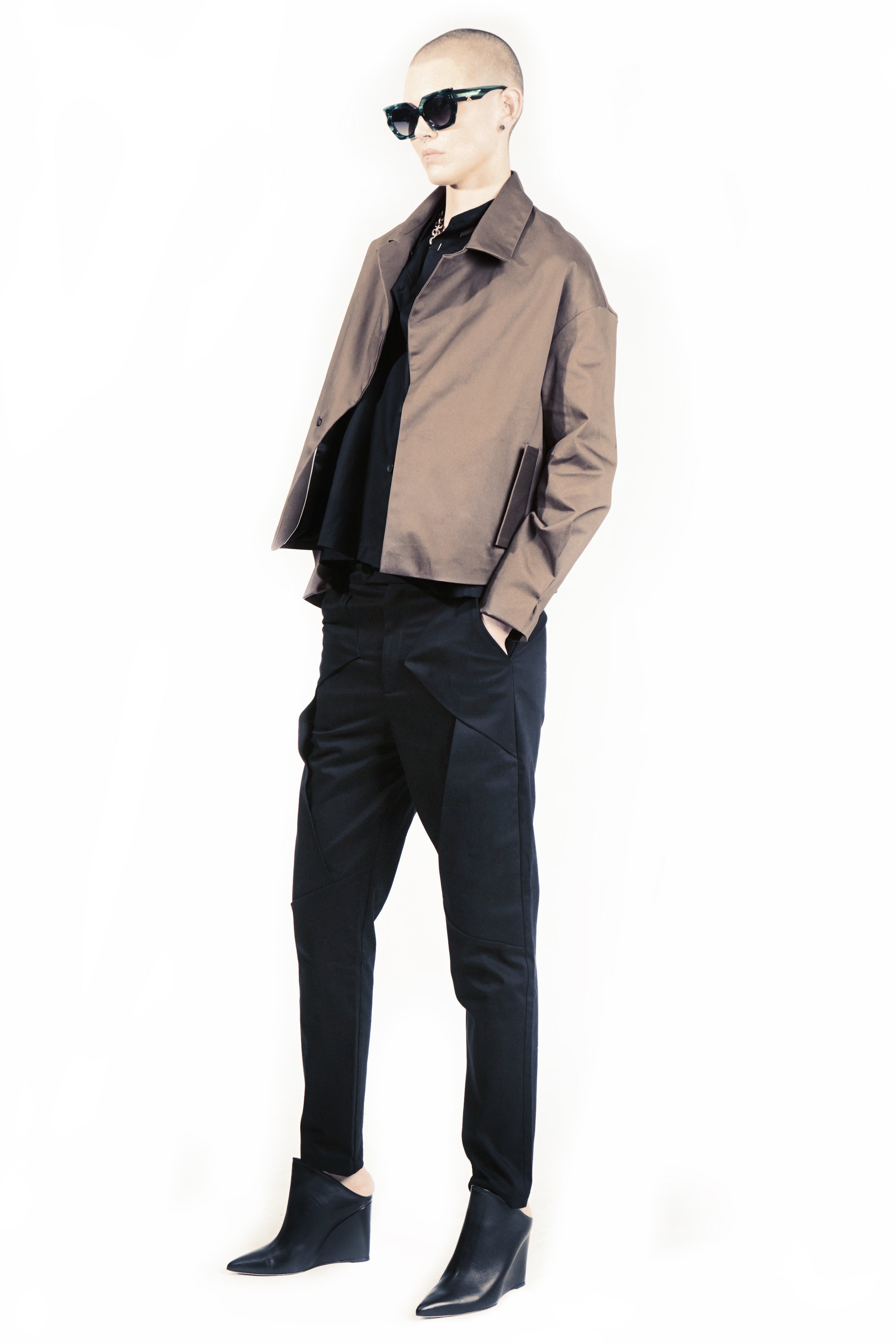 Side view of layered cotton trousers with narrow silhouette