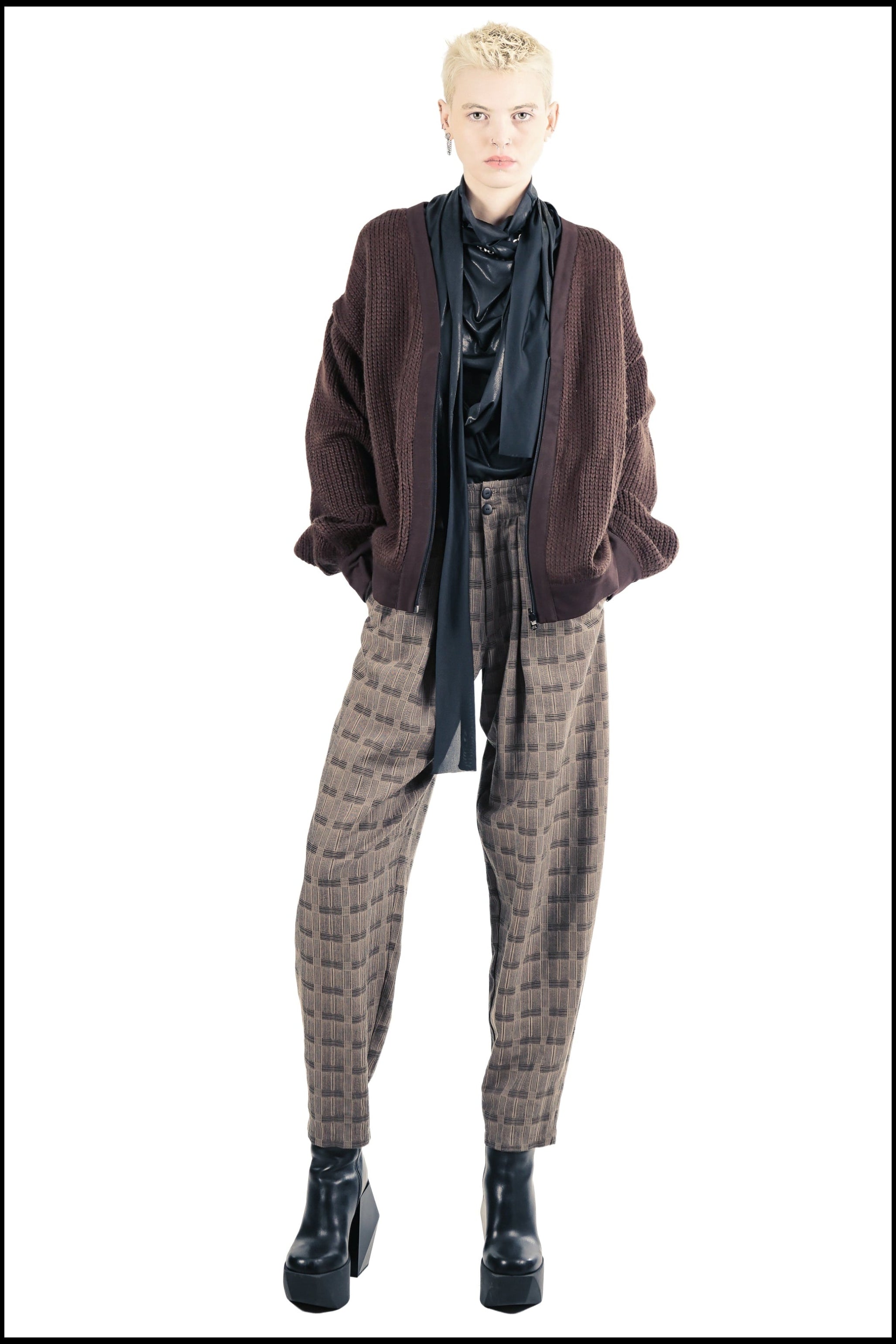 Unisex brown cardigan styled with patterned trousers