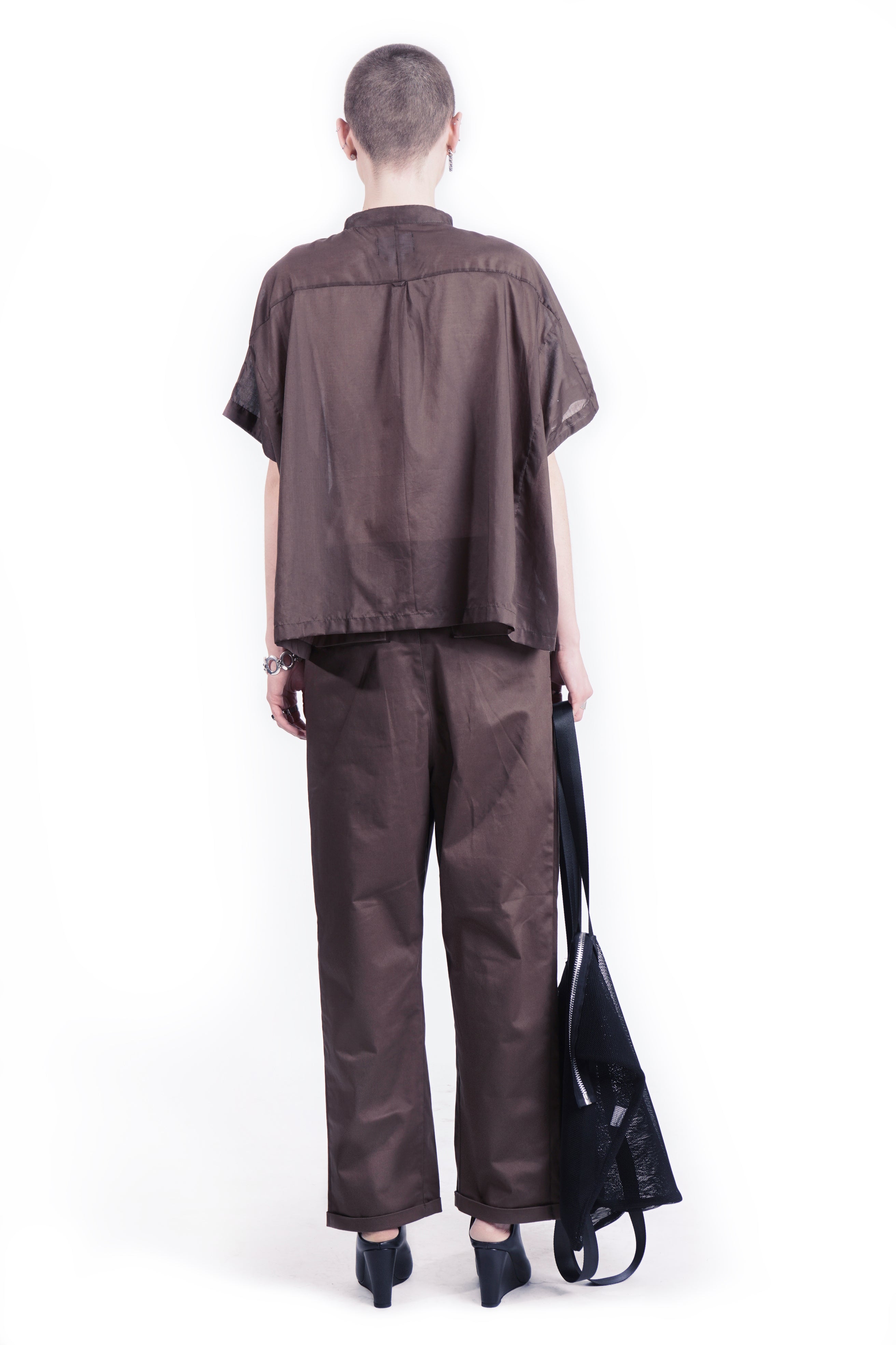 Back view of oversized white blouse with stand collar