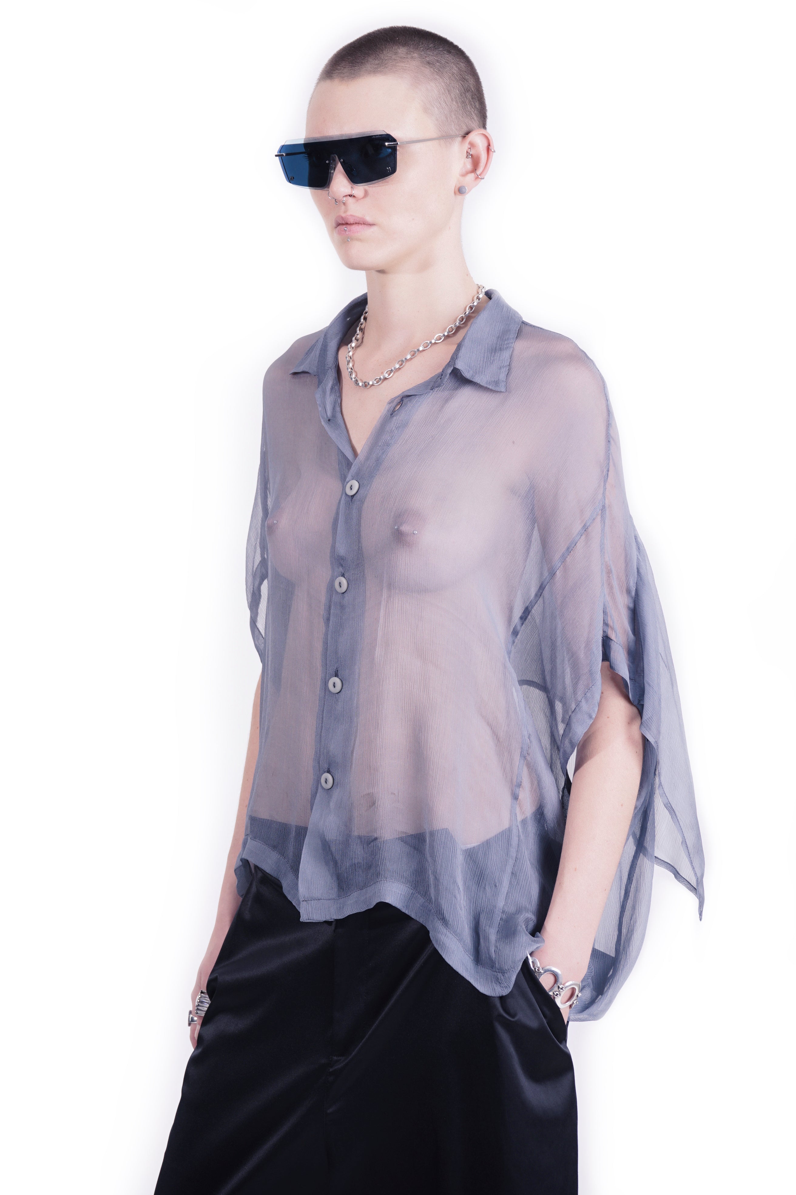Side detail  view of oversized blue silk  blouse with mandarin collar and back layer 