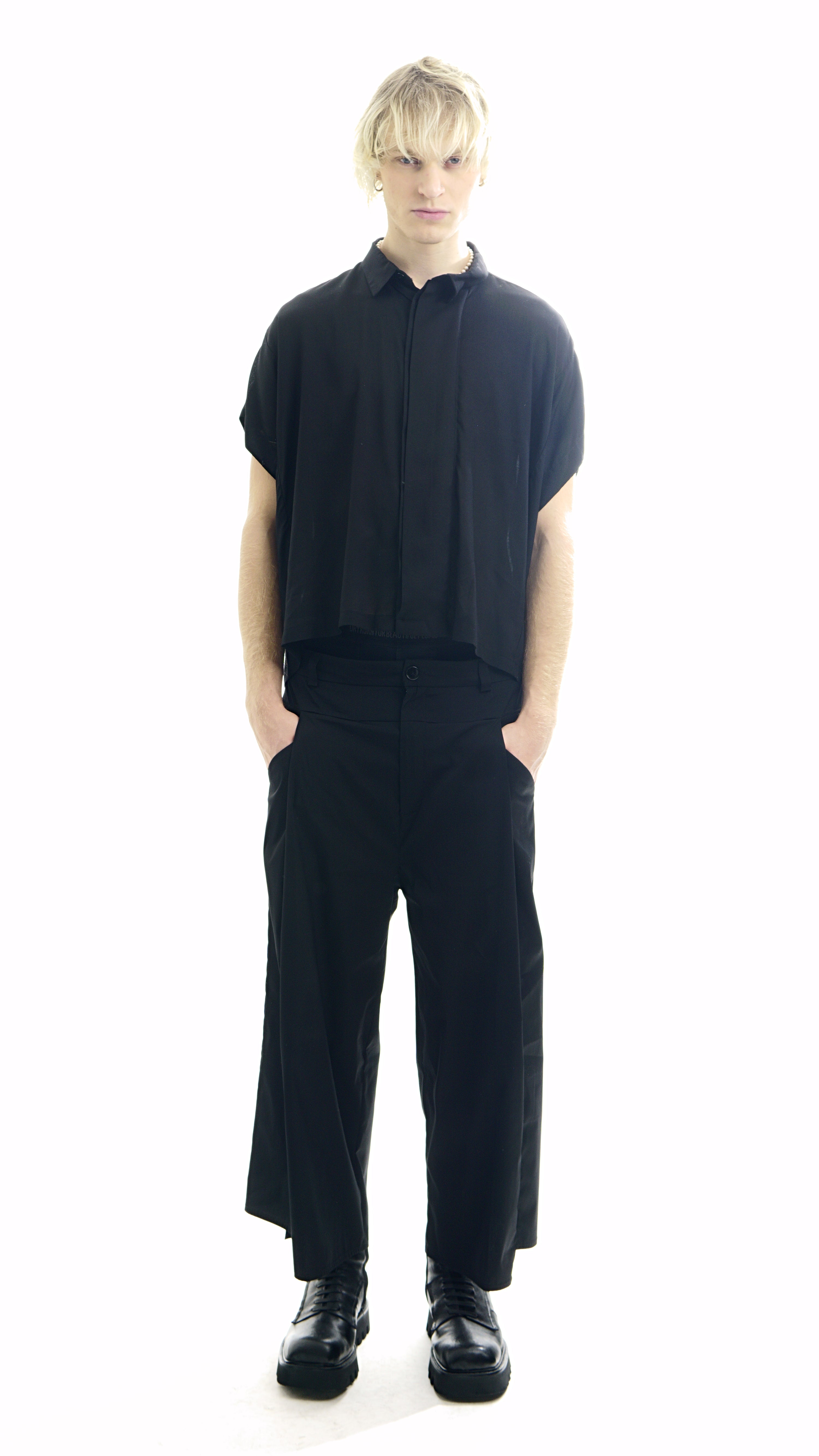 Front view of oversized black blouse with concealed closure
