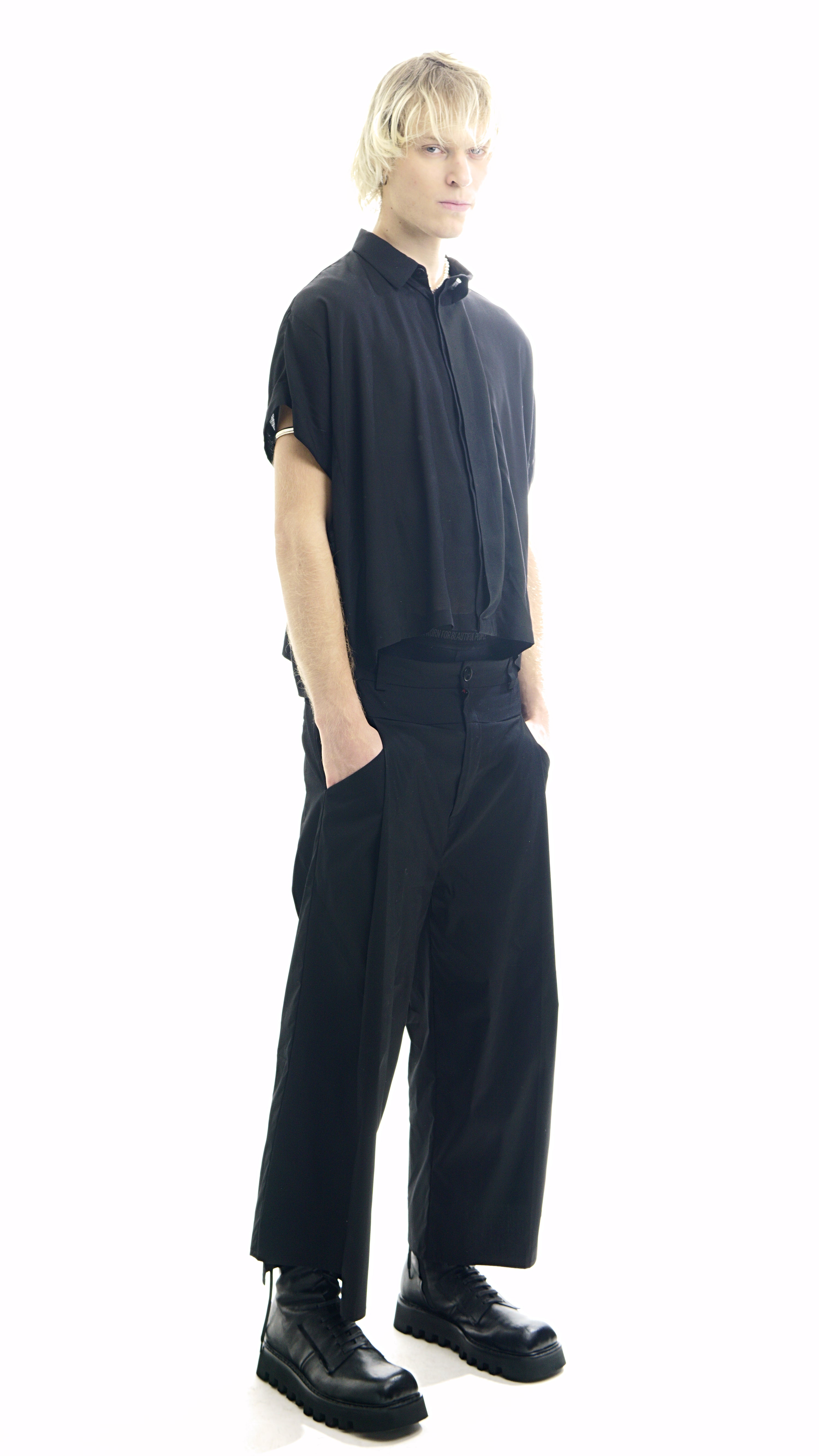 Side view of relaxed oversized blouse with hodden buttons 
