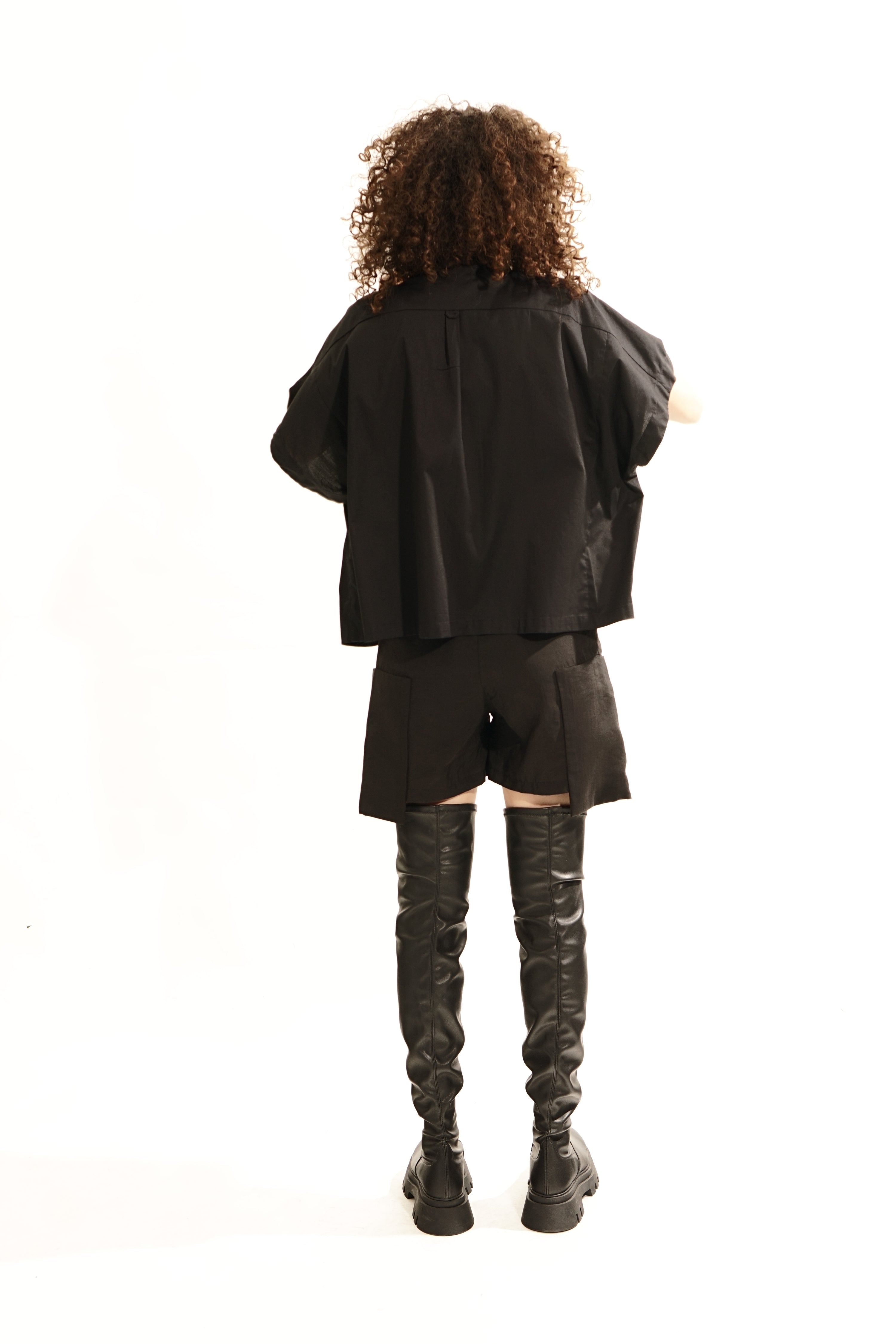 Back view of oversized black wide blouse with mandarin collar and concealed Buttons 