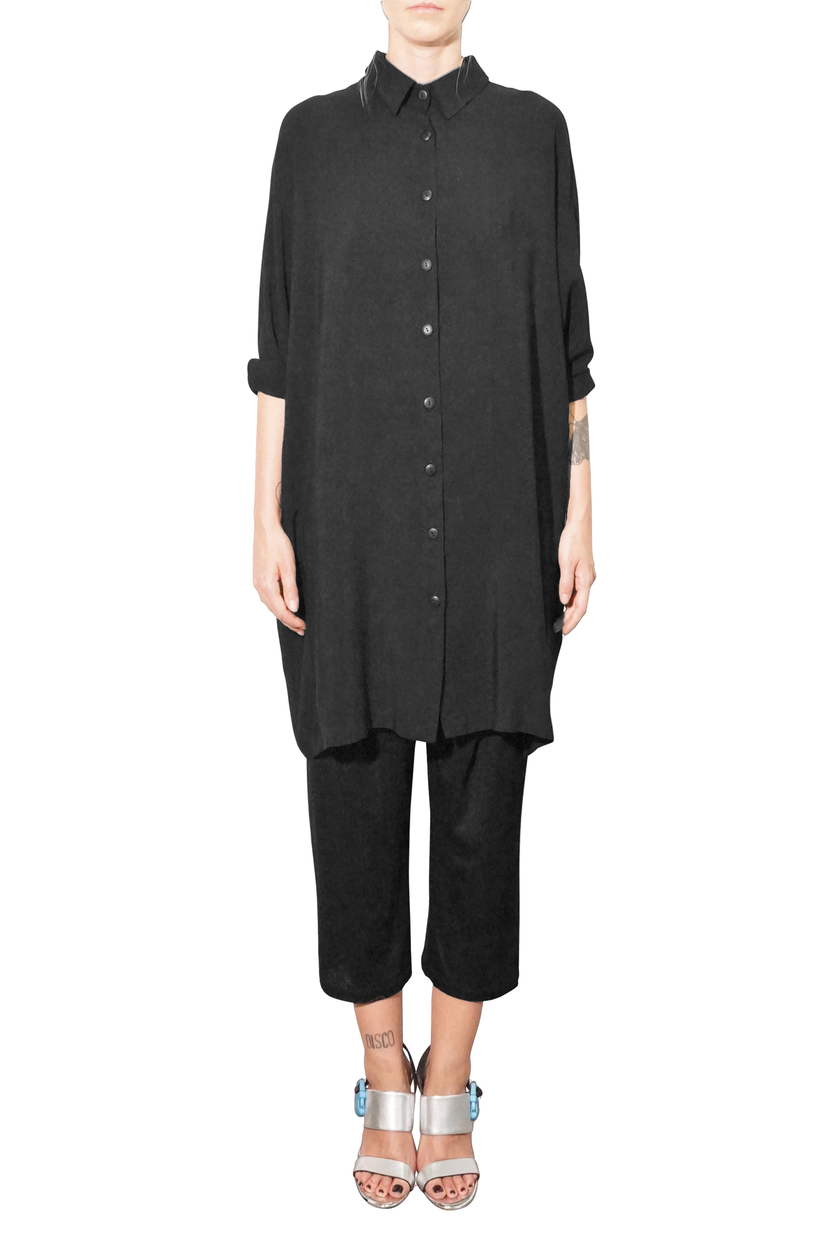 Front view of oversized black shirt dress with fluid fabric