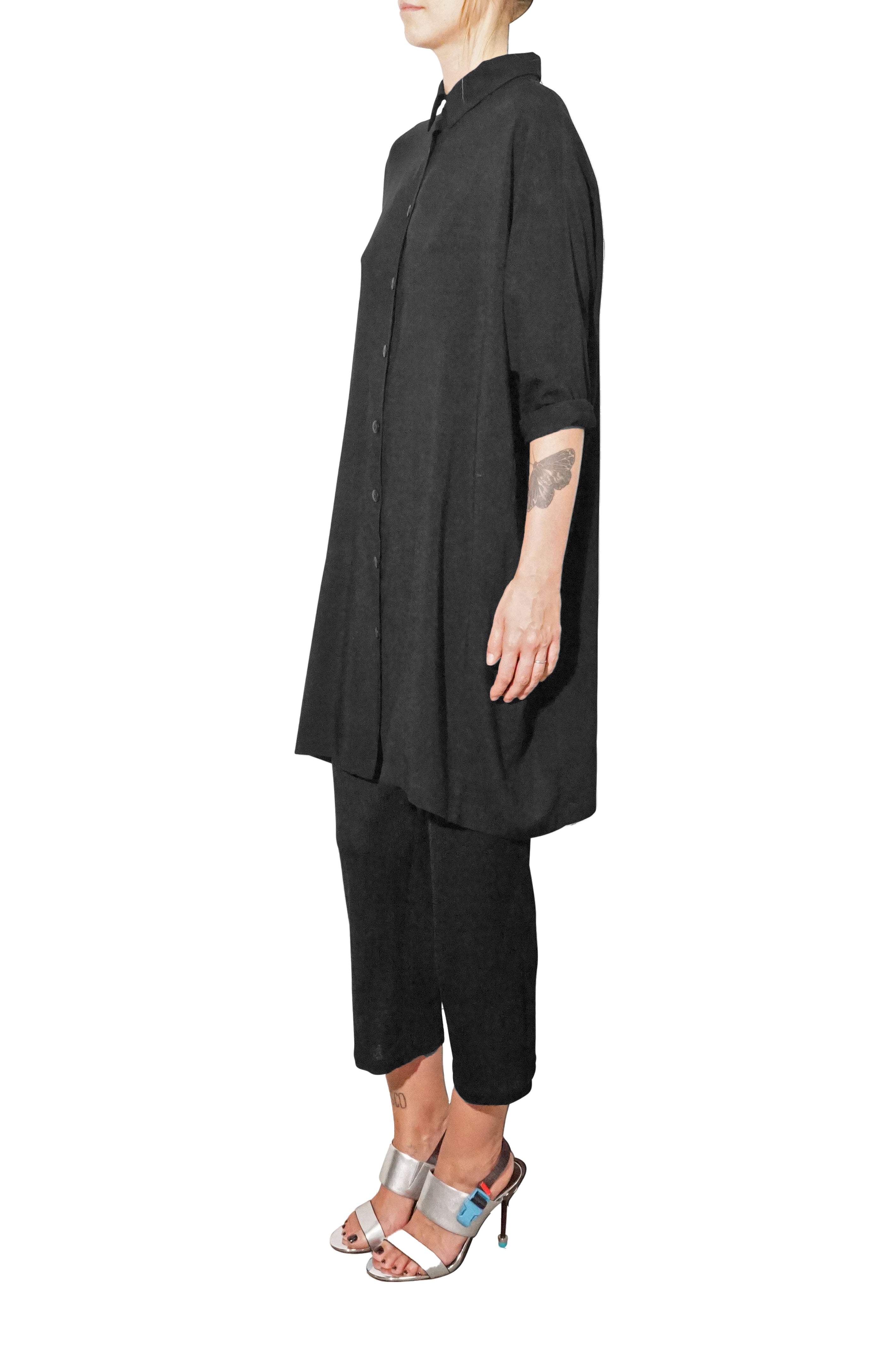 side  view of oversized black shirt dress with fluid fabric adddress